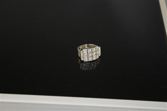 A white metal (stamped 750 and Pt 950) and pave diamond set cocktail ring, of curved design and set with twenty round cut stones.